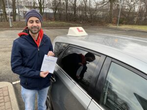 learner holding pass certificate at M&M driving school