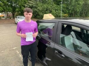 learner holding pass certificate M&M driving school