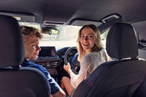 Teenagers having fun travelling by car