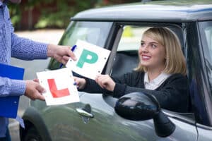 learner holding L plate and P plate M&m driving school 1